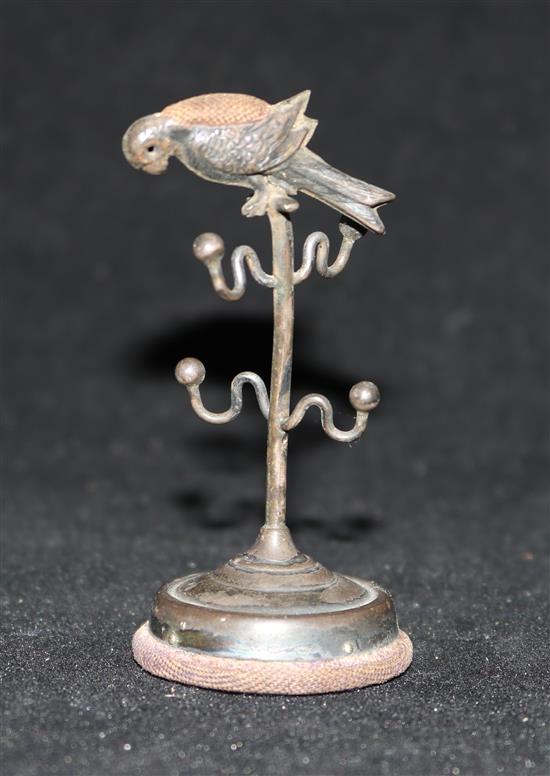 An Edwardian silver parrot perch ring stand/pin cushion, by Adie & Lovekin, Birmingham, 1909, 7cm.